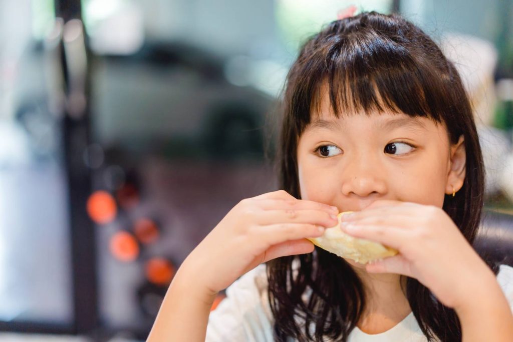 A child eating a sandwich