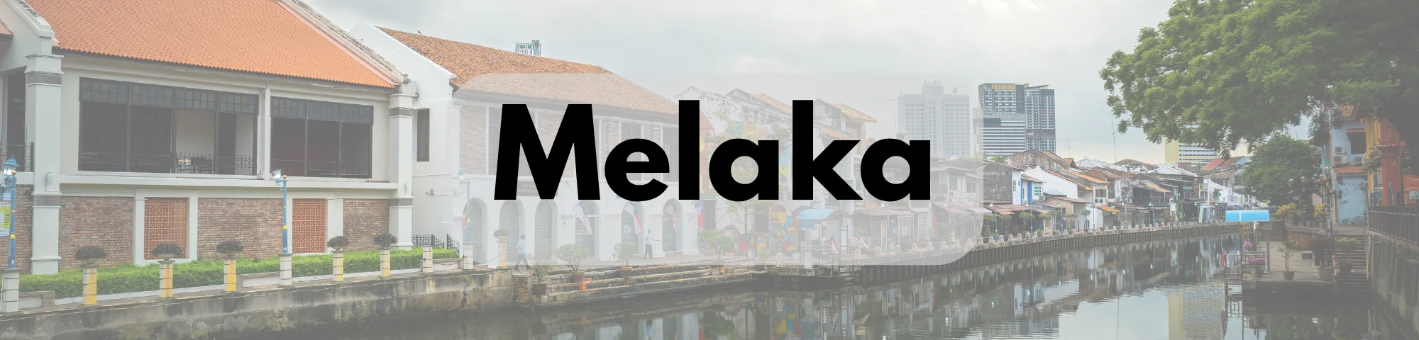 Scenic view of Melaka’s historic riverside, featuring traditional colonial-style buildings with red-tiled roofs, a calm river, and lush greenery, with the word “Melaka” prominently displayed.