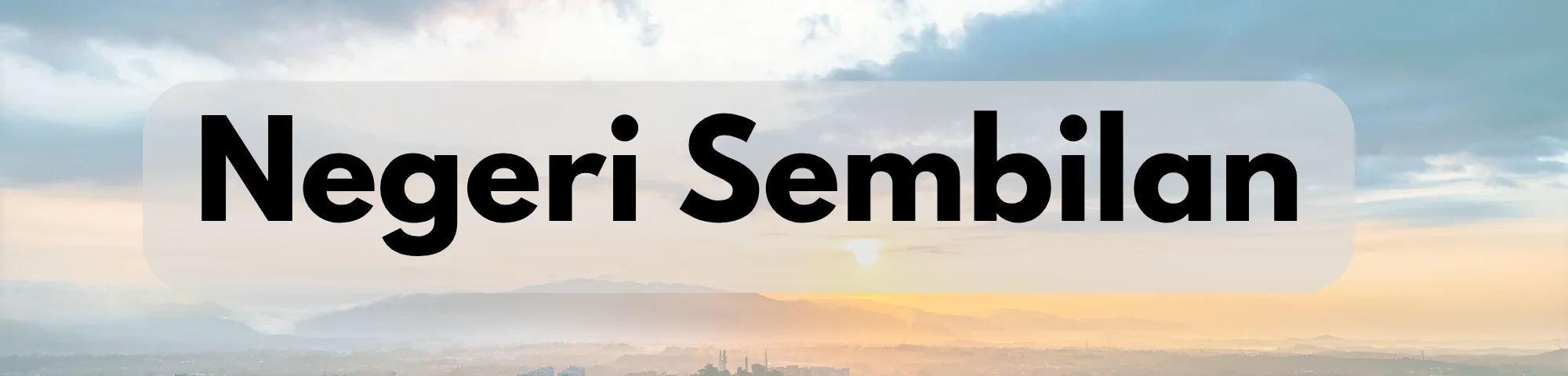 Panoramic landscape of Negeri Sembilan featuring distant mountain ranges beneath a cloudy sky and a warm sunset glow, with the words “Negeri Sembilan” prominently displayed.